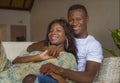 Lifestyle home portrait of young happy and successful romantic African American couple in love relaxed sitting comfortable Royalty Free Stock Photo