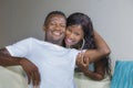 Lifestyle home portrait of young happy and successful romantic African American couple in love relaxed sitting comfortable Royalty Free Stock Photo