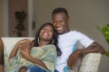 Lifestyle home portrait of young happy and successful romantic afro American couple in love relaxed sitting comfortable together Royalty Free Stock Photo