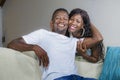 Lifestyle home portrait of young happy and successful romantic afro American couple in love relaxed sitting comfortable together Royalty Free Stock Photo