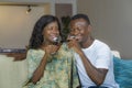 Lifestyle home portrait of young romantic and happy black African American couple in love drinking wine cup at living room couch Royalty Free Stock Photo