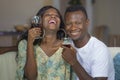 Lifestyle home portrait of young romantic and happy black African American couple in love drinking wine cup at living room couch Royalty Free Stock Photo