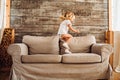 Lifestyle image of a little girl having fun and jumping on a sofa at home Royalty Free Stock Photo