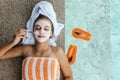 Teen girl applying organic fruit facial mask Royalty Free Stock Photo