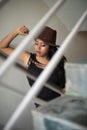 Lifestyle images of young Indian sexy girl in black western dress and cowboy hat on the landing of a staircase with railings