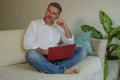 Lifestyle indoors portrait of young happy and attractive business man working with laptop computer from home comfortable at living Royalty Free Stock Photo