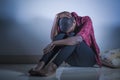 Lifestyle indoors portrait of young sad and depressed black african American woman sitting at home floor feeling desperate and wor Royalty Free Stock Photo