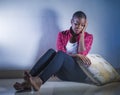 Lifestyle indoors portrait of young sad and depressed black african American woman sitting at home floor feeling desperate and wor Royalty Free Stock Photo