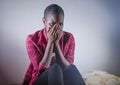 Lifestyle indoors portrait of young sad and depressed black african American woman sitting at home floor feeling desperate and wor Royalty Free Stock Photo