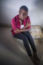 Lifestyle indoors portrait of young sad and depressed black african American woman sitting at home floor feeling desperate and wor Royalty Free Stock Photo