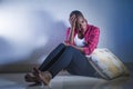 Lifestyle indoors portrait of young sad and depressed black afro American woman sitting at home floor feeling desperate and worrie Royalty Free Stock Photo