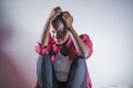 Lifestyle indoors portrait of young sad and depressed black afro American woman sitting at home floor feeling desperate and worrie Royalty Free Stock Photo