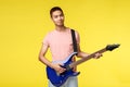 Lifestyle, leisure and youth concept. Portrait of smiling asian young man playing in band, holding electric guitar Royalty Free Stock Photo