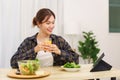 Lifestyle in living room concept, Asian woman watching movie on tablet and drinking orange juice Royalty Free Stock Photo