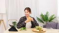 Lifestyle in living room concept, Asian woman watching movie on tablet and drinking orange juice Royalty Free Stock Photo