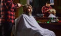 Lifestyle. master barber does the hairstyle and styling with dryer. Concept Barbershop. Young hipster man with beard Royalty Free Stock Photo