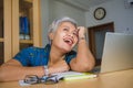 Lifestyle office portrait of attractive and happy successful middle aged Asian woman working at laptop computer desk smiling Royalty Free Stock Photo