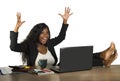 Happy and attractive black afro American businesswoman working excited with feet on computer desk smiling relaxed celebrating busi