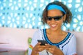 Lifestyle outdoors portrait of young attractive hipster and exotic looking girl happy and relaxed using internet social media on m Royalty Free Stock Photo