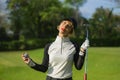Lifestyle outdoors portrait of young beautiful and happy woman at playing golf holding ball and putter club smiling cheerful in st Royalty Free Stock Photo