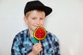 Lifestyle and people concept. Adorable little male child with blue eyes and fair hair in black cap and checked shirt posing with c Royalty Free Stock Photo