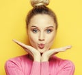 Beautiful blond woman with kiss gesture. Portrait of a flirting girl. Female with positive emotion. Close up.