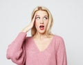 Beautiful girl surprised and shocked looks on you. Royalty Free Stock Photo