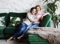 Lifestyle and people concept - Beautiful senior mom and her adult daughter are hugging, looking at camera and smiling. Royalty Free Stock Photo