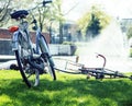 lifestyle people concept: couple of bicycle on green grass in summer park at fountain close up Royalty Free Stock Photo
