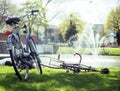 Lifestyle people concept: couple of bicycle on green grass in summer park at fountain Royalty Free Stock Photo