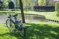 Lifestyle people concept: couple of bicycle on green grass in summer park at fountain Royalty Free Stock Photo