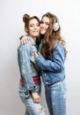 Lifestyle and people concept: Fashion portrait of two stylish girls best friends, over white background. Happy time Royalty Free Stock Photo