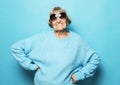 Lifestyle and people concept: Happy grandmother wearing blue sweater smiling