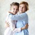 Lifestyle and people concept: Happy senior mother embracing adult daughter laughing together Royalty Free Stock Photo