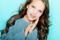 Lifestyle and people concept: litle girl kid with long curly hair, studio shoot. Royalty Free Stock Photo