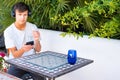 Lifestyle and people concept. Man sitting outdoor and looking at the mobile phone in their hands Royalty Free Stock Photo