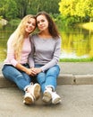 Lifestyle and people concept: mature mother and adult daughter hugging in the park Royalty Free Stock Photo