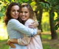 Lifestyle and people concept: mature mother and adult daughter hugging in the park Royalty Free Stock Photo