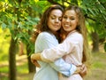 mature mother and adult daughter hugging in the park on a summer day Royalty Free Stock Photo