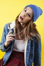 lifestyle people concept: pretty young school teenage girl having fun happy smiling on yellow background Royalty Free Stock Photo