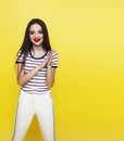 Lifestyle people concept: pretty young school teenage girl having fun happy smiling on yellow background Royalty Free Stock Photo