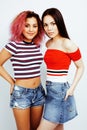 Lifestyle people concept: two pretty stylish modern hipster teen girl having fun together, diverse nation mixed races