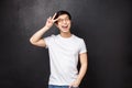 Lifestyle and people concept. Upbeat charismatic asian male model in white t-shirt and sunglasses express positivity and Royalty Free Stock Photo