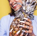 Lifestyle people concept. young pretty smiling indian girl with pineapple, asian summer fruits Royalty Free Stock Photo