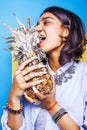 Lifestyle people concept. young pretty smiling indian girl with pineapple, asian summer fruits