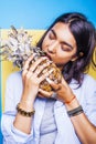 Lifestyle people concept. young pretty smiling indian girl with pineapple, asian summer fruits Royalty Free Stock Photo