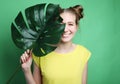 Lifestyle and people concept: young woman with a leaf