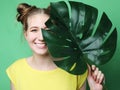 Lifestyle and people concept: young woman with a leaf