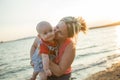 Lifestyle photo normal family with baby boys on the ocean coast