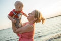 Lifestyle photo normal family with baby boys on the ocean coast